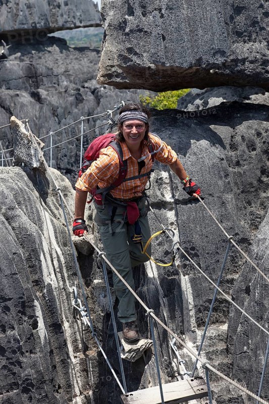 Tourist crossing a suspension bridge in the Great Tsingy de Bemaraha limestone formations