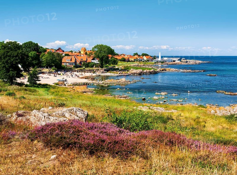 View of Allinge with bathing area and smokehouse on the rocky coast of the Baltic Sea
