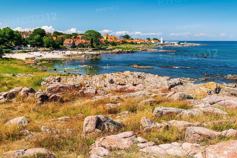 View of Allinge with bathing area and smokehouse on the rocky coast of the Baltic Sea