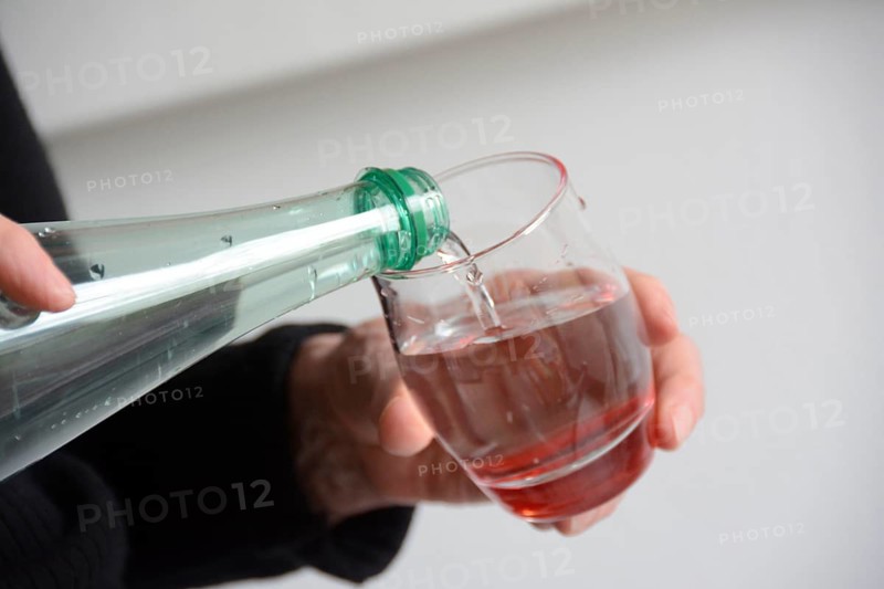Water being poured from a bottle into a glass