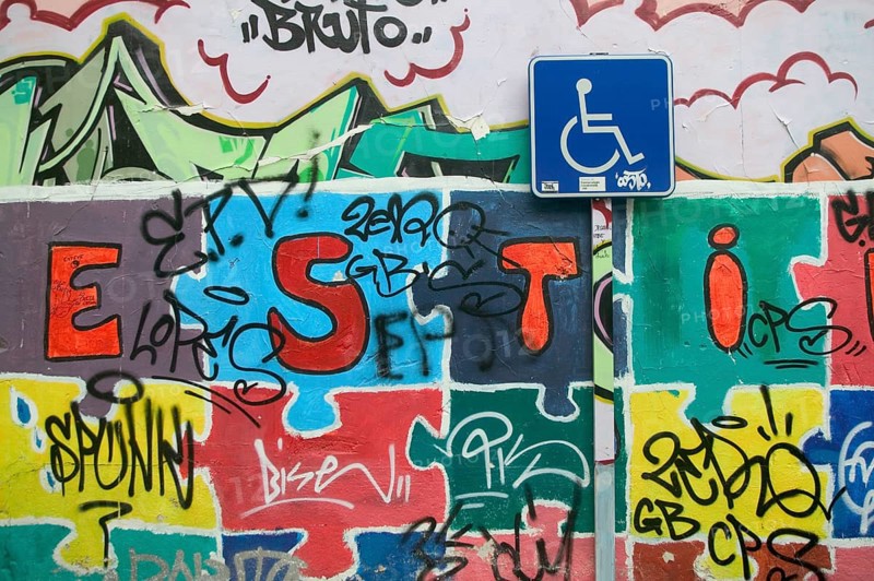Sign Parking for disabled and wall covered with graffiti