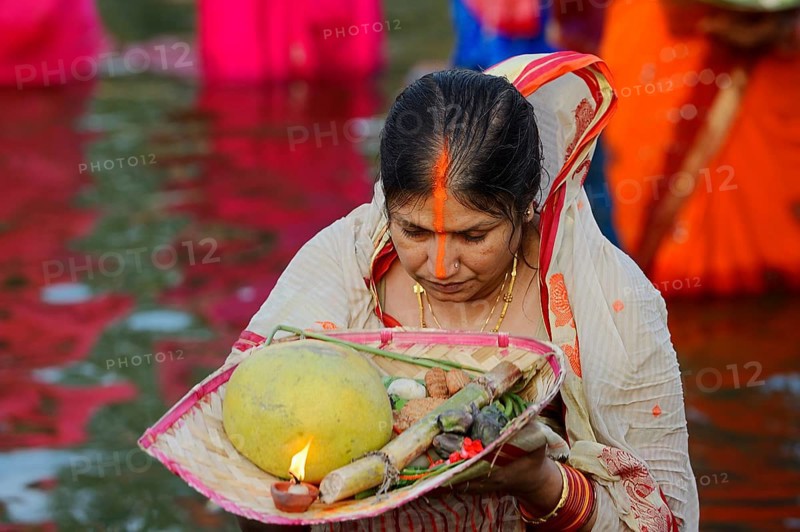 Woman wearing a sari with offerings during the Hindu Chhath Festival