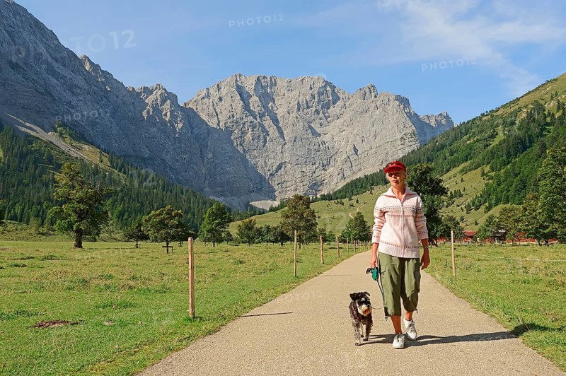Woman hiking with a Miniature Schnauzer
