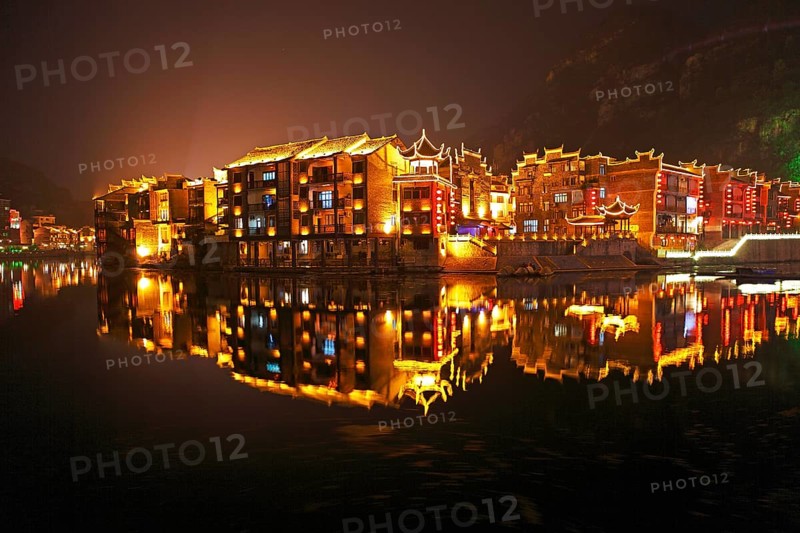 Illuminated houses on the Wuyang River at night