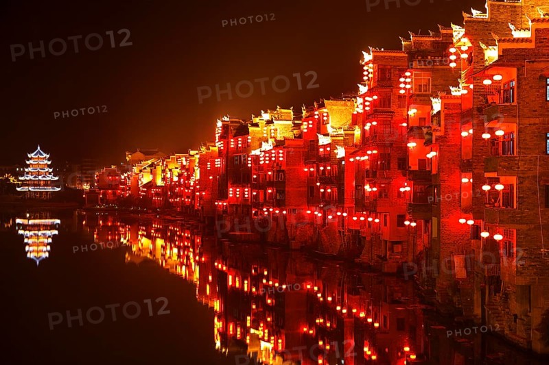 Red illuminated houses on the Wuyang River at night