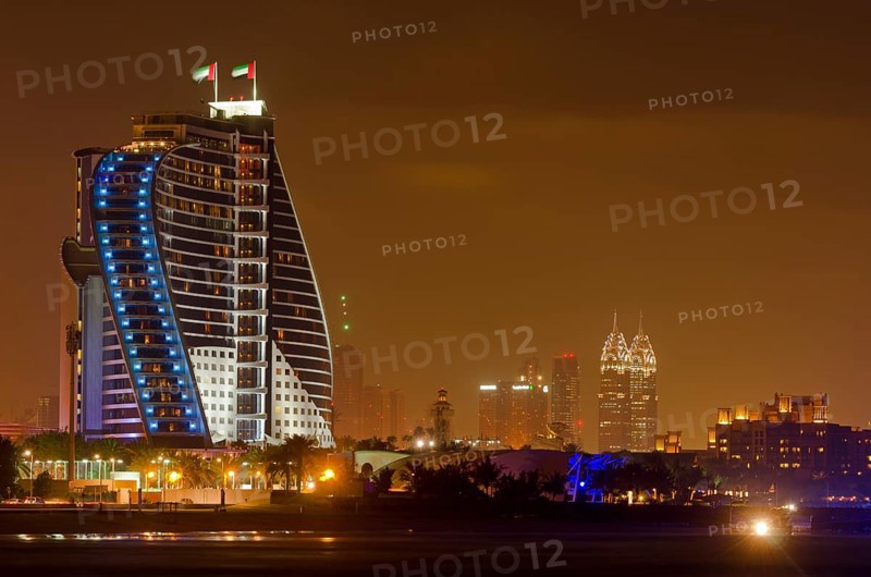 The illuminated Jumeirah Beach Hotel on Jumeirah beach at dusk