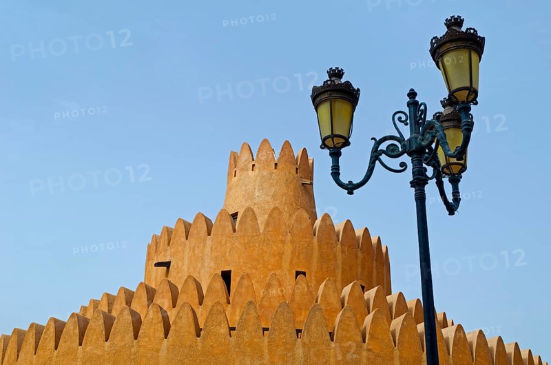 A tower of the Al Ain Palace Museum or Sheikh Zayed Palace Museum and a street lamp