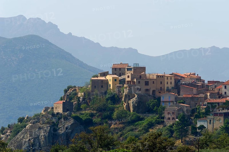 The small village of Montegrosso in front of the steep mountains of Corsica