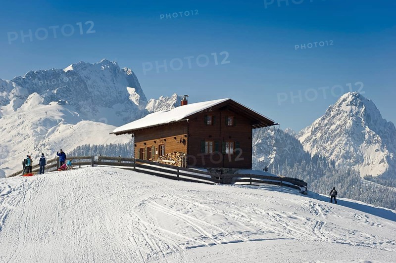 Wooden house on a snow-covered hill, Mt Alpspitze