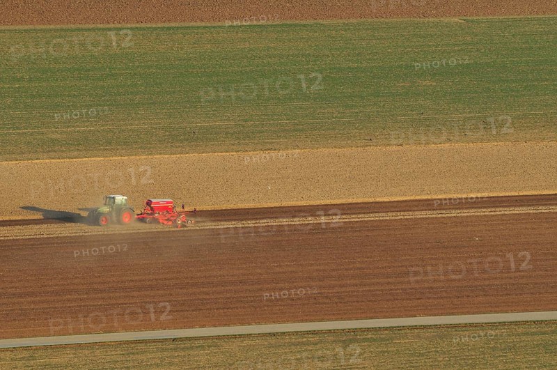 Tractor plowing fields in spring