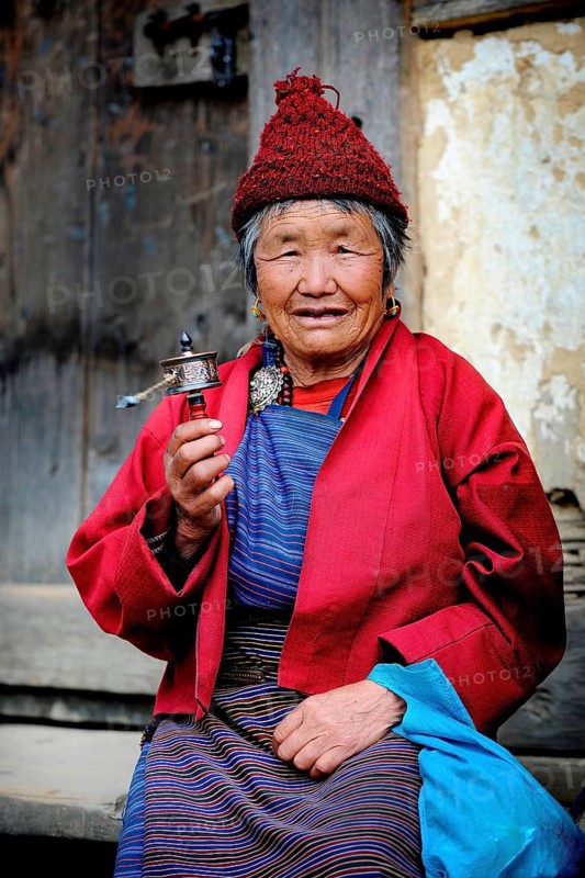 Woman holding a prayer wheel