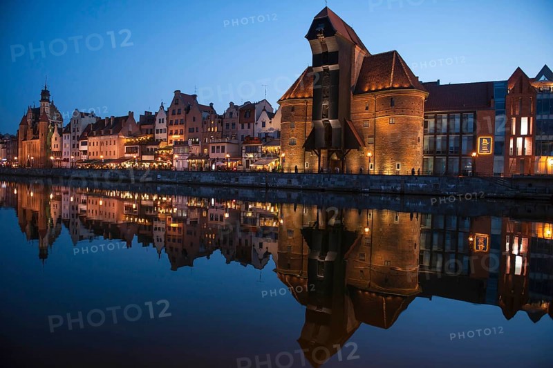 Crane Gate or Brama Zuraw in the historic row of houses at dusk