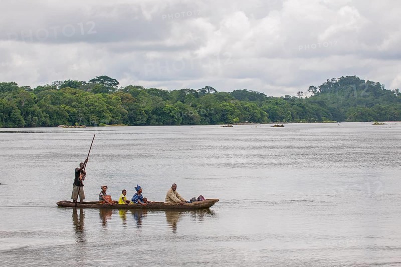 Ferryman taking passengers across the Moa River in a pirogue