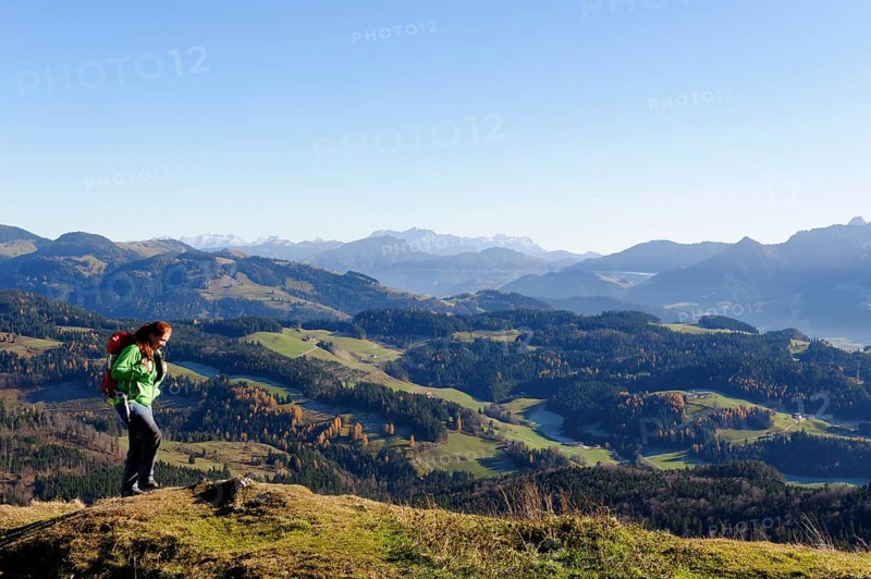 Hiker with views from Kranzhorn mountain towards the Loferer Steinberge mountains and Zahmer Kaiser mountain