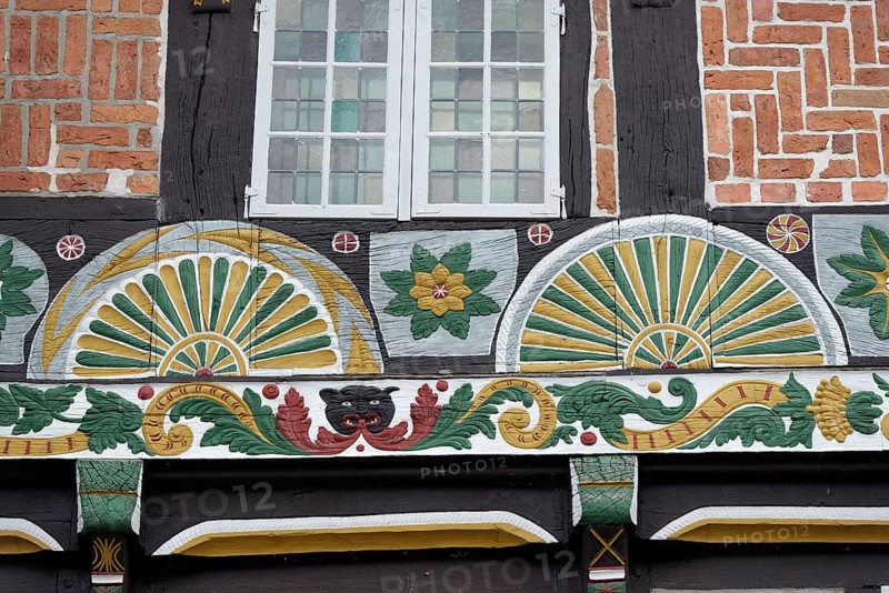 Half-timbered house with painted fan rosettes