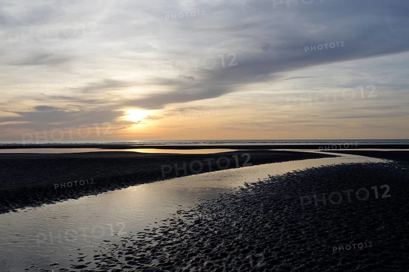 Sunset over a beach at low tide