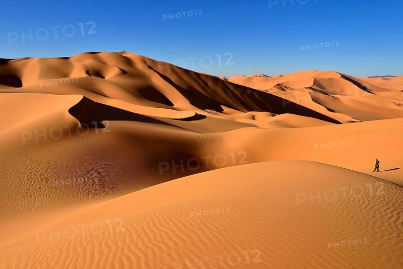 Person walking on a sand dune