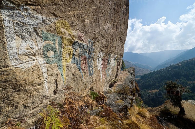 Om mani padme hum mantra painted at a big rock