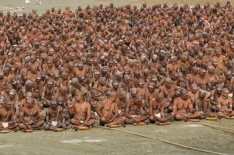 Taking their first meal in the new live as part of the initiation of new sadhus at the Sangam