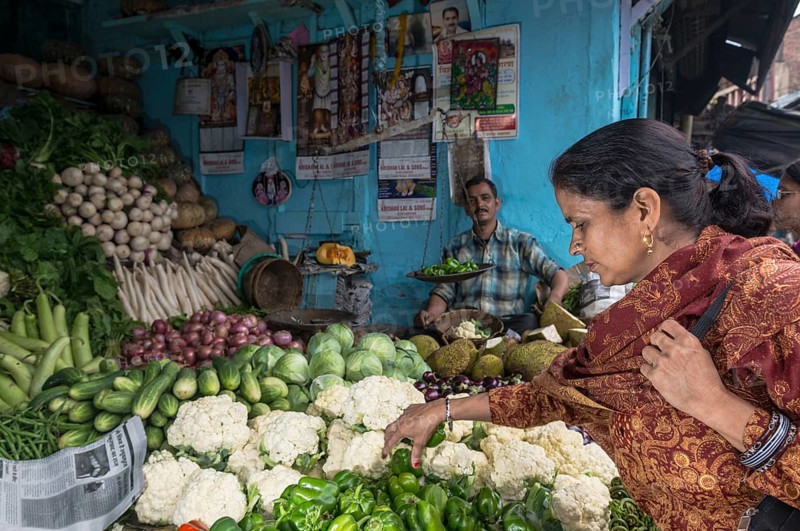Local woman buying cauliflower at the market