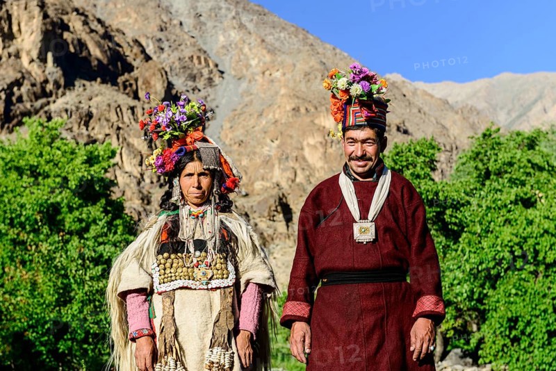 A couple of the Brokpa tribe wearing traditional dresses with flower headdresses
