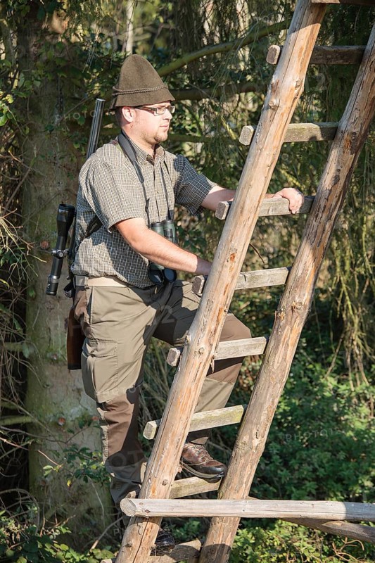 Hunter climbing a raise hide