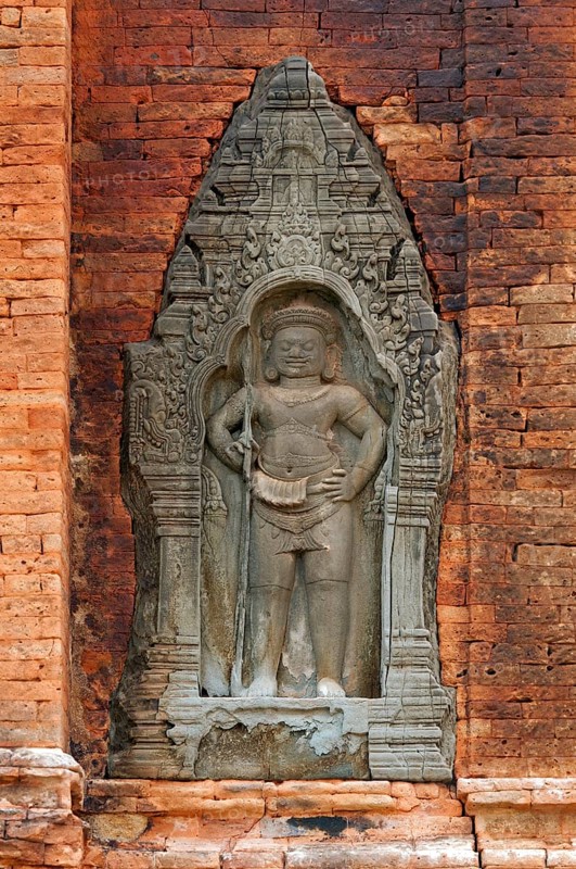 Bas-relief of a male guardian figure holding a trident-spear in his hand