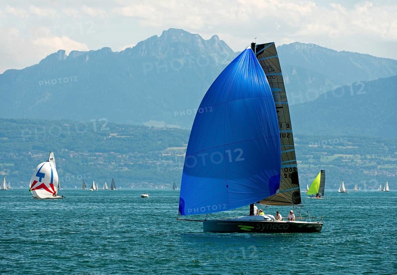 Sailboat of the Luthi 870 type with spinnaker headsail on Lake Geneva near Morges