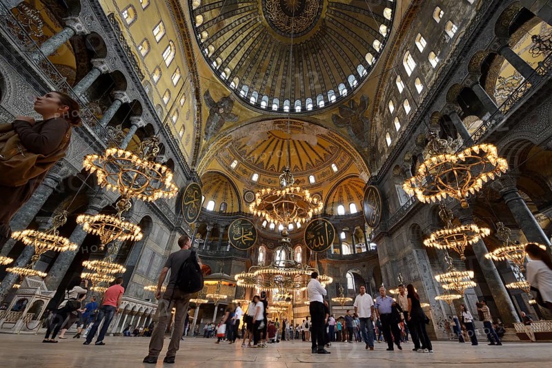 Tourists admiring the main hall of Hagia Sophia