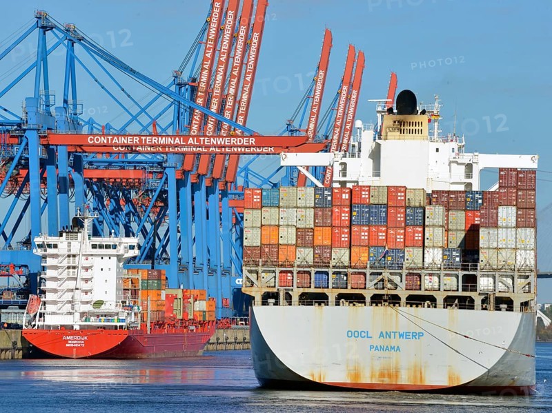 Container ship OOCL Antwerp with a feeder ship
