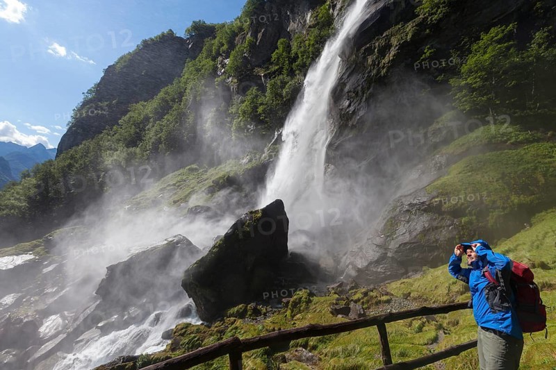 A man hiking at the waterfall of Foroglio