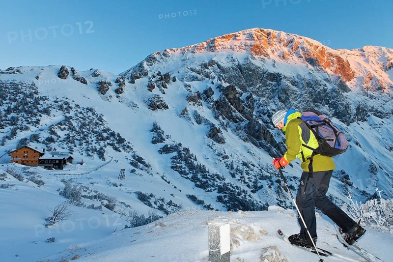 Man snowshoeing towards Carl-von-Stahl-House on Torrener Joch pass