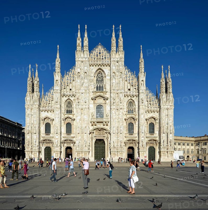 Tourists in front of the west facade of Milan Cathedral or Duomo di Santa Maria Nascente