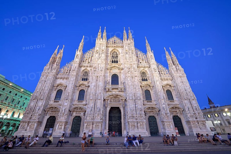 Tourists in front of the west facade of Milan Cathedral or Duomo di Santa Maria Nascente
