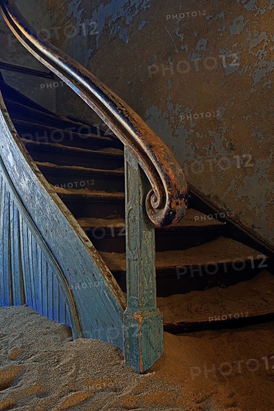 Staircase in a house that has been filled by desert sand