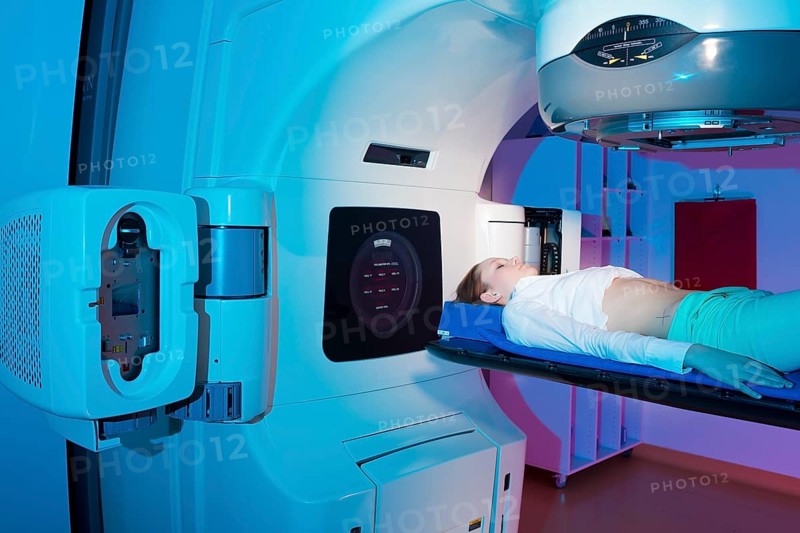 Patient lying in a linear particle accelerator for radiation treatment