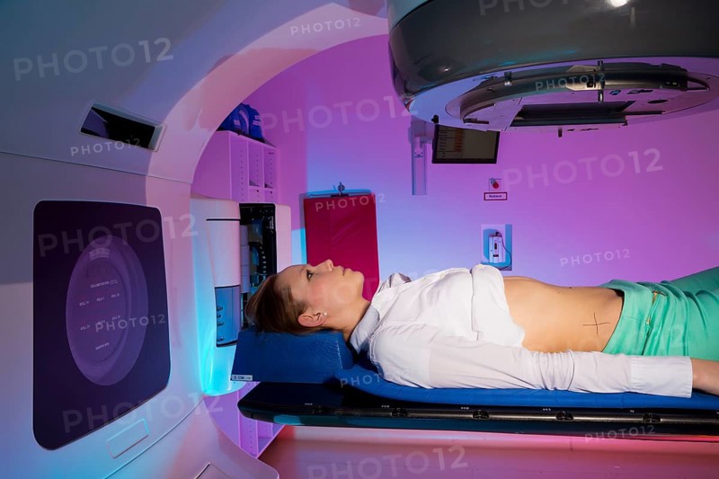 Patient lying in a linear particle accelerator for radiation treatment