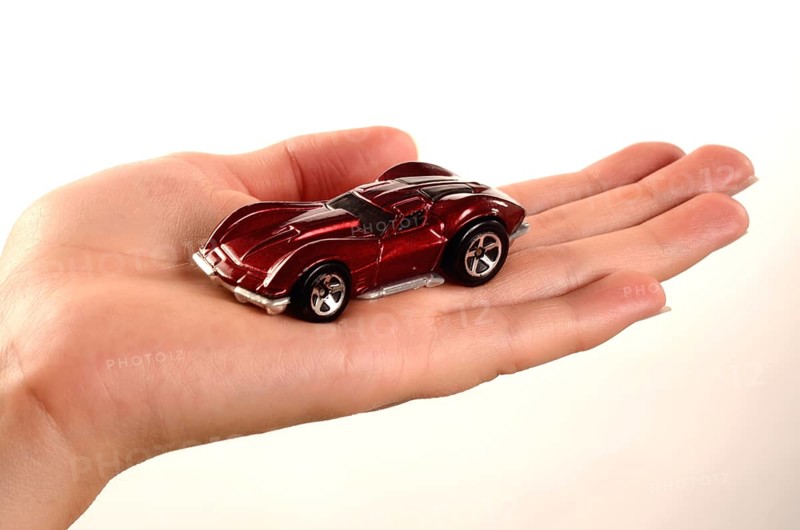 Hand holding a miniature car