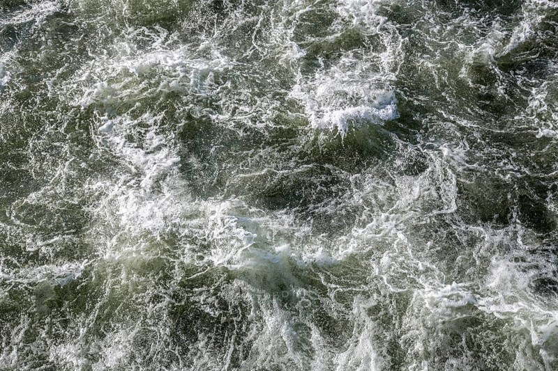 Rough waters of a river swirling after emerging from a barrage