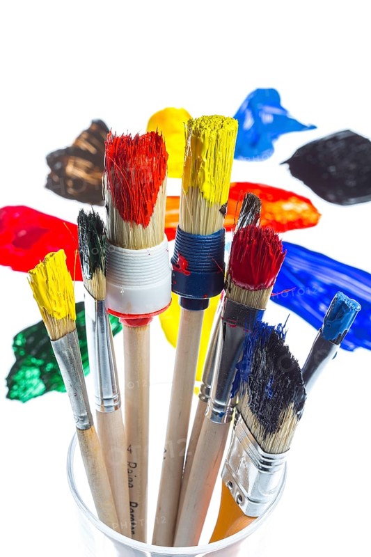 Different types of brushes with colourful acrylic paints