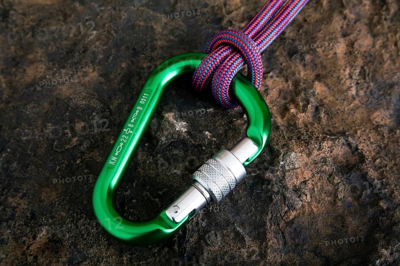 Carabiner with safety rope on a stone surface