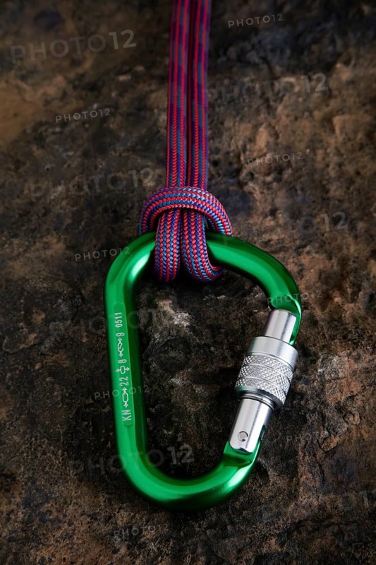 Carabiner with safety rope on a stone surface
