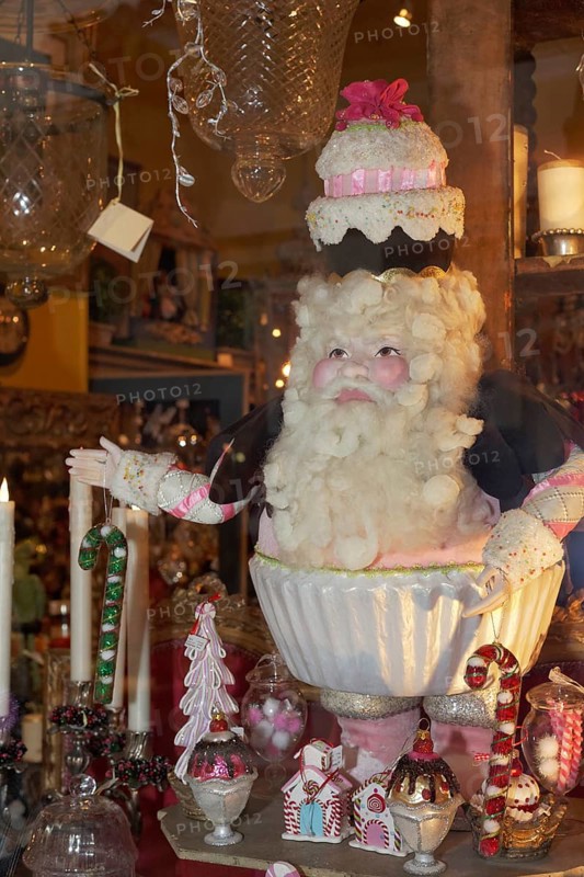 Santa Claus figure with a cake on its head