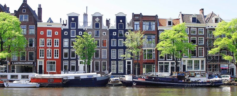 Typical canal houses and boats along the Amstel Canal