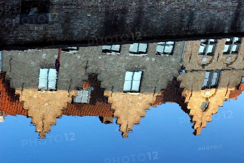 Guild houses with stepped gables being reflected in Dijver canal
