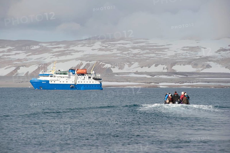 Passengers returning after being ashore in Zodiac inflatable boats to the expedition cruise ship