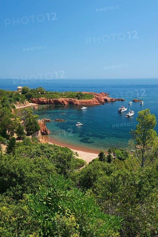 Calanque bay with boats at Cap Roux in the Esterel mountains