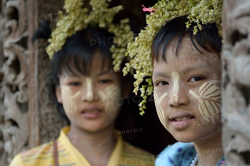 Young girls with thanaka and flower decoration