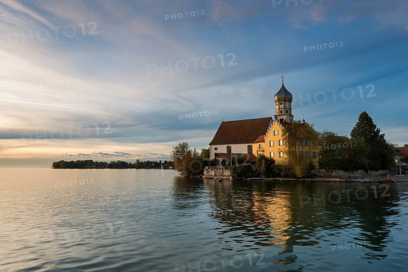 Evening mood with the Baroque Church of St. George on the banks of Wasserburg am Bodensee