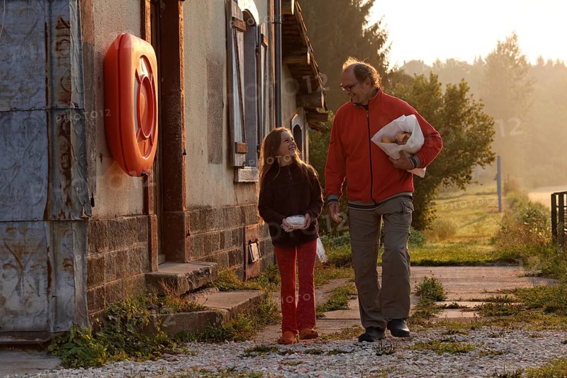 Father and daughter shopping for bread in the early morning
